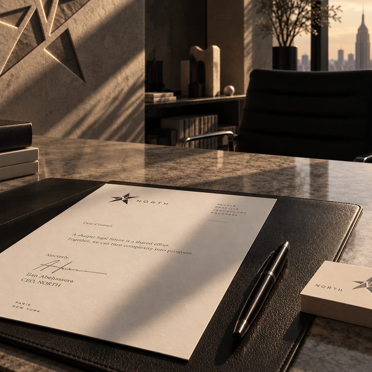 A North letterhead signed by Ilan Abehassera, CEO, next to a pen on a leather desk pad, with a city skyline through the window behind